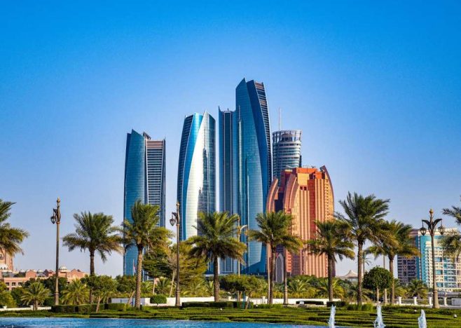 Abu,Dhabi,Downtown,With,Palm,Trees,In,The,Background